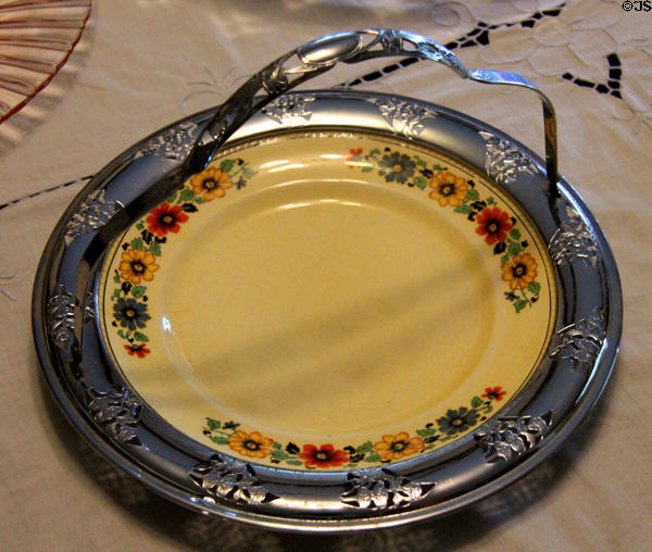Porcelain serving dish in metal basket on dining table at Chambers House Museum. Beaumont, TX.