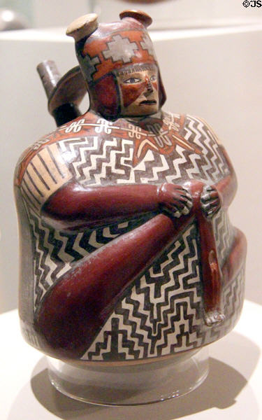 Ceramic Nazca-culture single-spout strap-handle vessel of wounded warrior (500-600) from south coast, Peru at Dallas Museum of Art. Dallas, TX.