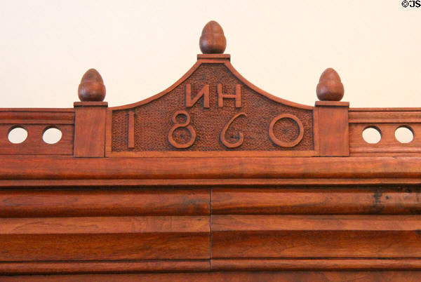Crown with acorns of wardrobe (1860) with initials NH commemorating the marriage of Nicholas Holtz at Museum of Texas Handmade Furniture. New Braunfels, TX.
