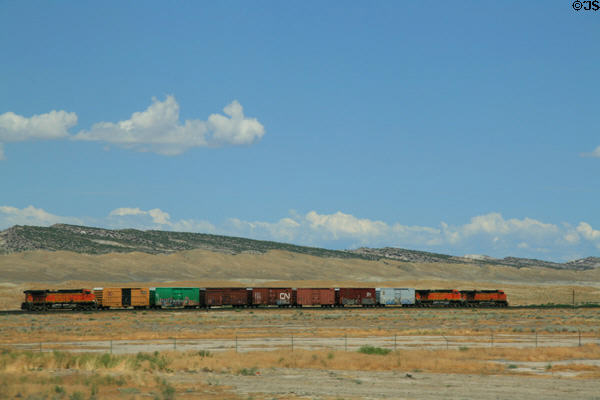 Small freight train running along Highway US6 / US191 West of Green River, Utah. UT.