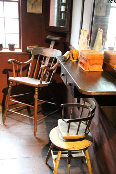 Barber shop with elevated chair with headrest & swivel child's chair in General Store at Shelburne Museum. Shelburne, VT.
