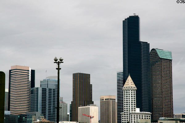 Skyline of Seattle from south with Wells Fargo Center, bluish Fourth & Madison, 901 Fifth Ave. through pointed Smith Tower & tall Columbia Center & Seattle Municipal Towers. Seattle, WA.
