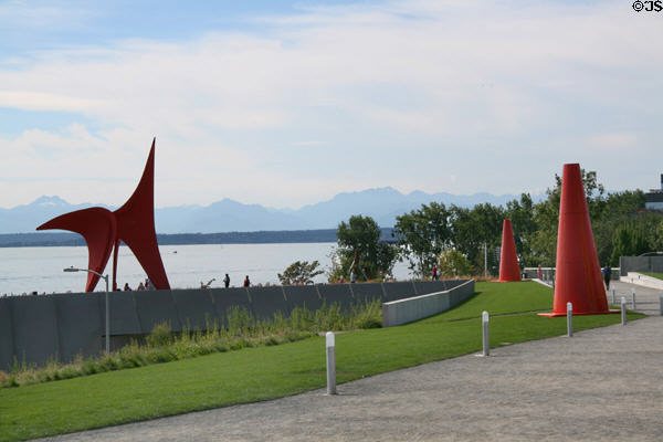 Path of Olympic Sculpture Park zigzags down to Elliott Bay with Olympic mountain ranges in distance. Seattle, WA.
