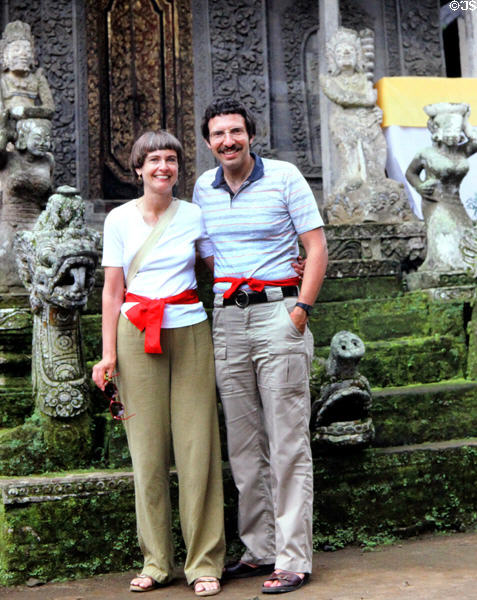 Visitors wearing required temple scarves at Balinese religious site. Bali, Indonesia.