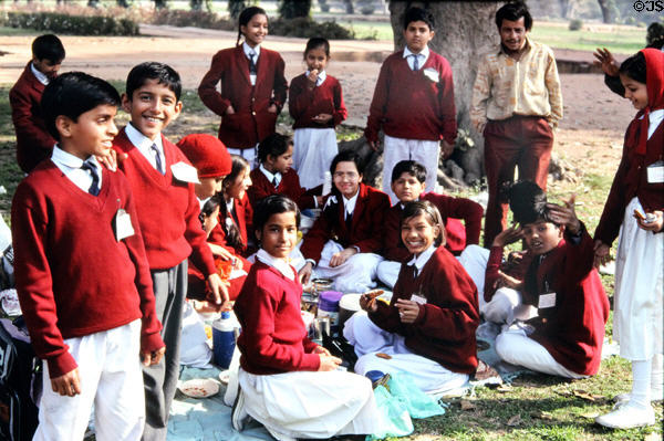 Uniformed school children picnicking at Humayun Tomb. Delhi, India.