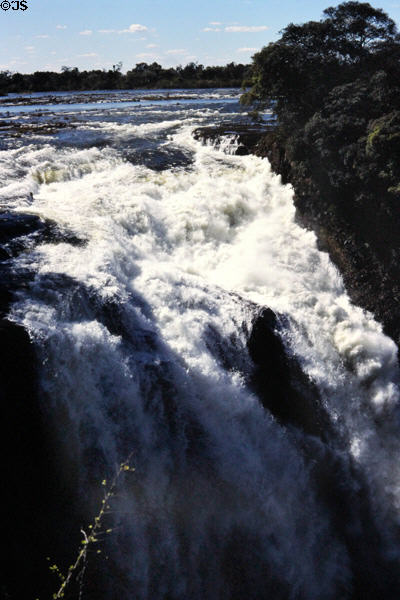 Zambezi River cresting over Victoria Falls. Zimbabwe.
