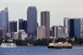 Boats float past Sydney Skyline. Sydney, Australia.