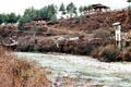 Prayer flags hang from a rope bridge in Paro on trail climbing to Takstang. Bhutan.