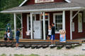 Visitors drive rail spikes at Craigellachie. Craigellachie, BC.