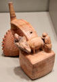 Sicán earthenware whistling bottle with double chambers shaped like thorny oyster & llama with two attendants from North Coast Peru at Gardiner Museum. Toronto, ON.