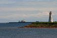 Lighthouse & ship at end of Confederation Bridge to PEI. PE.