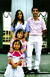 Family poses with Templo de Música in the center of Parque Morazán in San José. Costa Rica.