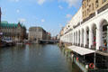 Historic Venetian-style arcade along Kleiner Alster canal with Bucerius Kunst Forum on opposite bank. Hamburg, Germany.