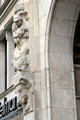 Versmann-Haus carvings of aproned man holding sheep & a cow's head on City Hall Market square. Hamburg, Germany.