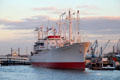 Profile of Museum Ship Cap San Diego, a German built cargo ship on Elbe River at dusk. Hamburg, Germany.