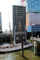 Sailing ship on Elbe River passing though lift bridge in front of Elbphilharmonie in HafenCity. Hamburg, Germany.