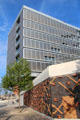 Decorative brickwork of flood barrier in front of modern office building on Dalmannkai in HafenCity. Hamburg, Germany.