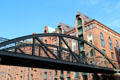 Kibbelsteg elevated pedestrian walkway with heritage warehouses on Am Sandtorkai. Hamburg, Germany.