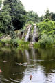 Waterfall flowing into pond in Palm Gardens. Frankfurt am Main, Germany.