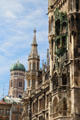 Corner tower of Neues Rathaus with domed spire of Frauenkirche beyond. Munich, Germany.