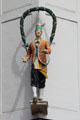 Oktoberfest celebrant statue with arch of hops on corner of Marienhof. Munich, Germany.