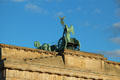 Winged victory riding quadriga chariot by Johann Gottfried Schadow atop Brandenburg Gate. Berlin, Germany.