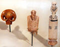 Egyptian predynastic bone amulets of bull's head, comb with head of man & figure at Neues Museum. Berlin, Germany.