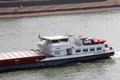 Barge with family car on deck traveling along Rhine River. Köln, Germany.