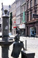 Statue at water fountain in front of St Severin Church. Köln, Germany.
