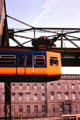 Hanging monorail leaving station. Wupperthal, Germany.