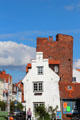 Streetscape with white end of building & semiround tower. Lübeck, Germany.