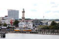 Warnemünde Lighthouse of Warnow river over Selene tourboat. Rostock, Germany.