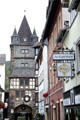 Typical town street with ancient Market Tower at the end. Bacharach, Germany.