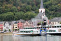 Sightseeing boat with St. Goar in the background. St. Goar, Germany.