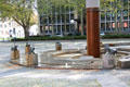 Water Clock Fountain with animal sculptures marking the hour & representing periods of Trier's history by Karl Jakob Schwalbach beside the Red Tower. Trier, Germany.