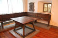 Bavarian farmer's sitting room with corner bench & square table with stretchers at Bavarian National Museum. Munich, Germany.