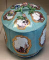 Meissen porcelain turquoise lidded vessel with branch-shaped handle & with scenes of commercial voyages painted in white areas framed with gold at Meissen porcelain museum at Lustheim Palace. Munich, Germany.