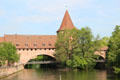 Fronveste & Schlayer Tower over Kettenteg suspension bridge & Pegnitz River. Nuremberg, Germany.