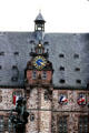 Steep roof & clock tower on Rathaus with statue of St. George vanquishing the dragon by Rudolf Breidenbach. Marburg, Germany.