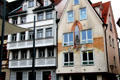 Ulmer Museum buildings lining Marktplatz with historical mural. Ulm, Germany.