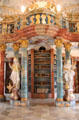 Book shelves & statues depicting academic & religious virtues in library at Kloster Wiblingen. Ulm, Germany.