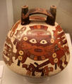 Nazca culture ceramic bridge-handle global vessel with figure painting from Peru at Museum of America. Madrid, Spain.