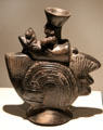 Lambayeque culture sculpted ceramic vessel with figure atop fish theme from North Coast, Peru at Museum of America. Madrid, Spain.