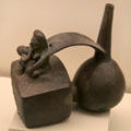 Chimu culture ceramic stirrup-spout bottle with mother nursing her child from Peru at Museum of America. Madrid, Spain.