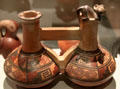Chimu culture ceramic stirrup-spout twin bottle with monkey from Peru at Museum of America. Madrid, Spain.