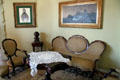 Sofa, chair & table in parlor of museum apartment at Casa Milà. Barcelona, Spain.