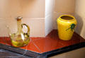 Glass flask & ceramic jar in kitchen of museum apartment at Casa Milà. Barcelona, Spain.