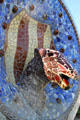 Lizard head plaque near steps of Parc Güell. Barcelona, Spain.
