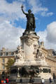 Bronze Marianne symbol of France atop carved monument representing liberty, equality, & fraternity over lion guarding ballot box by Charles & Léopold Morice at Place de la République. Paris, France