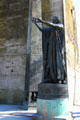 Statue of a man inviting onlookers to read texts on Monument of Human Rights on Champs de Mars. Paris, France.